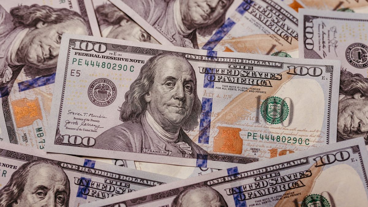 Stack of 100 dollar US banknotes with Benjamin Franklin portrait.